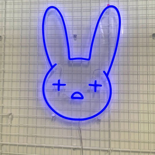 Neon sign featuring a rabbit face, representing the Bad Bunny Emoji, glowing brightly in vibrant colors.