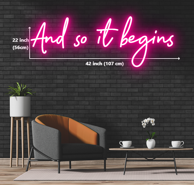 custom neon sign with the words 'and so it begins' glowing in vibrant colors, creating an eye-catching display.