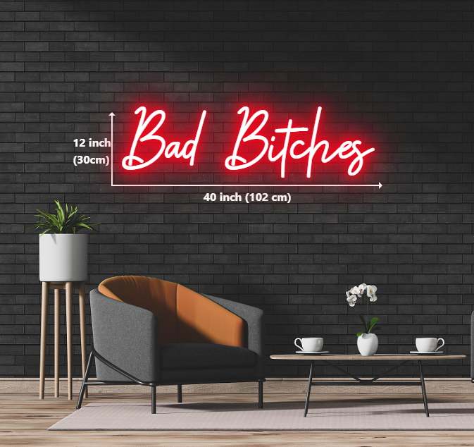 A neon sign displaying the phrase "bad bitches" in vibrant colors, illuminating a bold and empowering message.